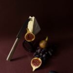 a knife and some fruit on a table